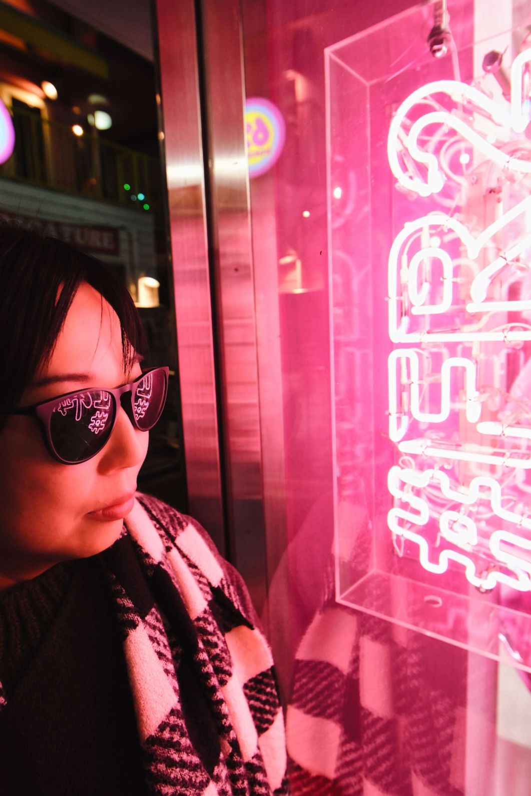 Having the neon lights reflect in the sunglasses is the point in these types of pictures, So you have to remember to focus on that.