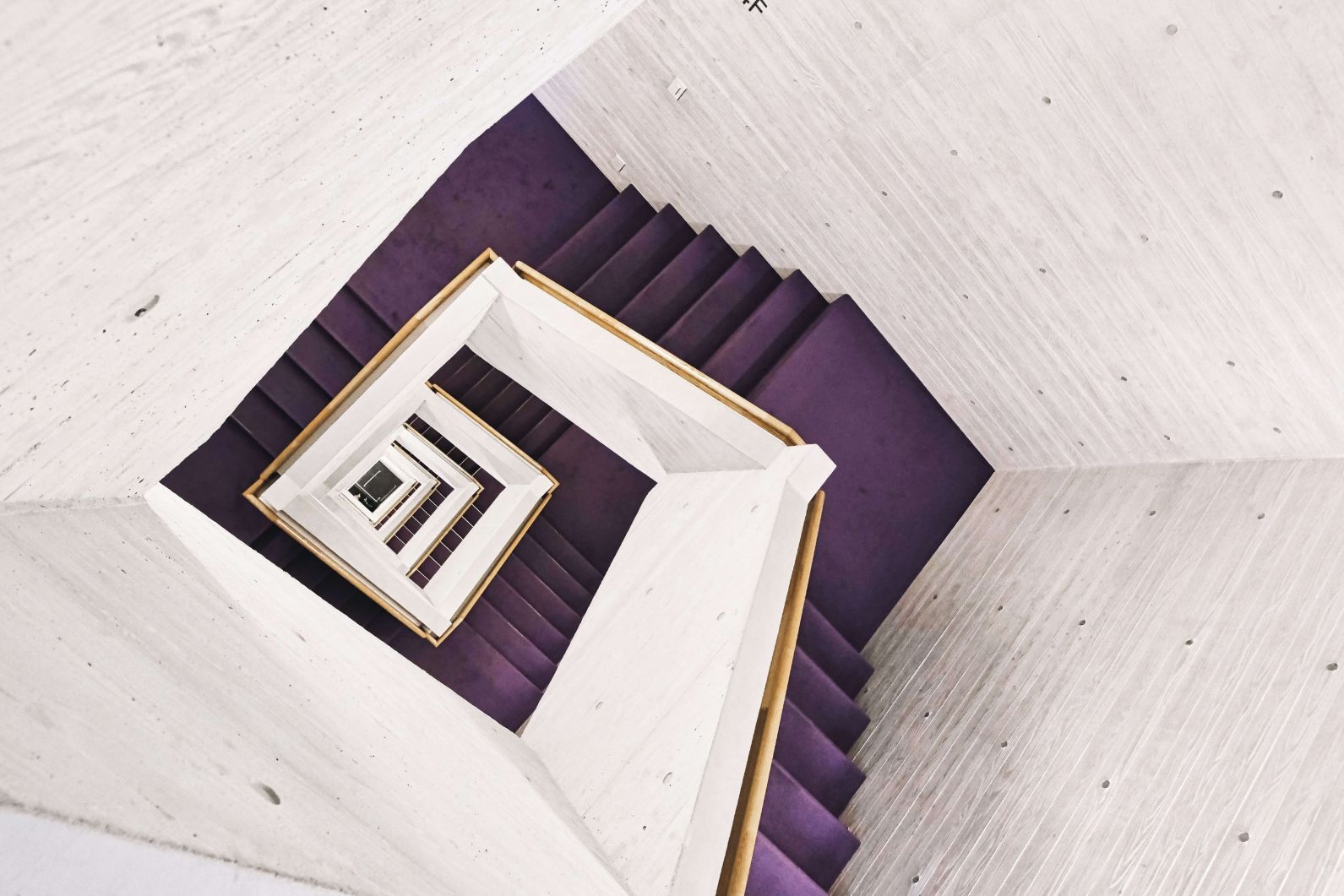 The purple carpet gives this spot a certain luxury vibe. The staircase is located in a religious building but is solemnly used.
